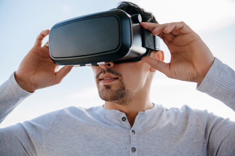 man wearing a VR headset holding the screen